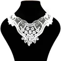 Close-up of white water-soluble lace neckline applique with intricate floral embroidery - White