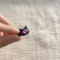 Detailed macro view of a cute black cartoon monster open ring featuring a pink eye design - Black