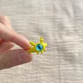 Detailed view of a cute yellow cartoon monster open ring with a prominent blue eye - Yellow