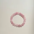 Detailed view of a handmade pink natural stone beaded bracelet with glossy finish - Aventurine Round Beads / Light Purple