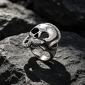 Gothic silver-colored skull ring with entwined snake design on dark rock background - US Size 9 / Silver Gray