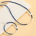 Detail view of blue crystal and freshwater pearl jewelry set with butterfly charms - Set / Crystal Blue