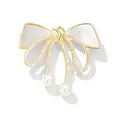 Elegant gold-tone bow brooch with shimmering rhinestones and delicate pearls for women. - Bow