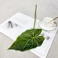 Detailed closeup of artificial alocasia leaf showcasing vibrant yellow veins and texture. - Single Caladium Leaf - Green with Yellow Center