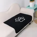 Washable black coral fleece pet mat with white paw print for sofa protection. - Black