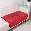 Soft red coral fleece washable pet pee pad with decorative black paw print design - Red