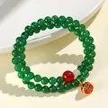 Ethnic green and red agate multi-strand beaded bracelet with health blessing charm. - Green Agate Abundance Fish Charm Style