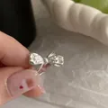 Elegant 925 sterling silver bow-shaped open ring with unique textured finish for women - Bowknot Pleated Style (JZ0717) / Adjustable Open / Silver