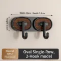 Oval 2-hook wall-mounted rack in black finish with dark wood grain accent panel - Oval 2-Hook Black