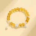 Bracelet en perles de citrine jaune avec perle d'eau douce et charm lotus en argent - Style Citrine