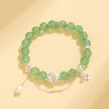 Elegante bracciale di perle verdi con ciondolo a loto, perla e dettaglio farfalla - Stile Quarzo Fragola Verde