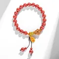 Elegant red cinnabar bead bracelet featuring a gold blessing charm and wooden flower. - Emperor Cinnabar Peach Blossom Bracelet