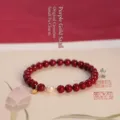 Elegant cinnabar bead bracelet featuring a white pearl and gold luck charm accessory. - Purple Gold Cinnabar Style / 15cm