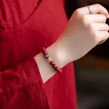 Elegant red cinnabar beaded bracelet for women with traditional enamel and gold-tone bead. - Purple Gold Cinnabar Enamel Bead Style / 8mm