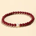 Elegant red cinnabar bead bracelet featuring a single white pearl centerpiece for women - 4MM Bead Diameter / 4mm Purple Cinnabar With White Pearl