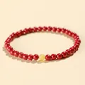 Elegant red cinnabar bead bracelet featuring a single translucent yellow bead for luck. - Emperor Cinnabar Artificial Amber Style / 4mm