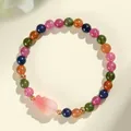 Multicolor tourmaline beaded bracelet with a pink maple leaf charm and gold spacers. - Fish Style