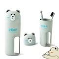 Detail of wheat fiber travel wash set featuring bear cup and two toothbrushes - Three-Piece Set / Green