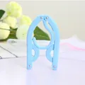 Blue portable folding clothes hanger made of durable plastic for travel and home use - Blue