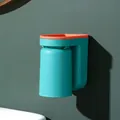 Wall-mounted teal and orange toothbrush holder with inverted mouthwash cup for bathroom - Green