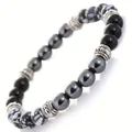 Detailed macro view of a natural stone beaded bracelet with hematite and black onyx - 8mm / Snowflake Stone (B+6+12)