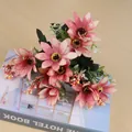 Close-up of pink artificial daisy bouquet with green leaves on a book - Orange Red