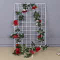 Artificial red rose vine wrapped around a white metal grid panel for home decor - Red