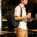 Large capacity black casual backpack for men shown in lifestyle setting - One Size / Black