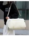 Shoulder carry view of a large cream white travel bag for gym and sports outdoors - White / One Size
