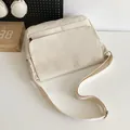 Minimalist cream white canvas messenger bag with multi-pocket design and adjustable strap - One Size / White