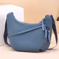 Stylish women's blue Oxford fabric hobo crossbody bag featuring decorative woven zipper pulls - One Size / Blue