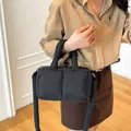Casual black puffer crossbody tote bag with soft padded handles and shoulder strap - Black