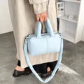 Soft light blue padded down tote bag featuring a comfortable puffy shoulder strap - Blue