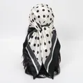 Close-up of a stylish white and black polka dot satin headscarf tied on a mannequin. - 70*70cm / FH179-01# Black