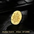 Vintage gold metal wax seal stamp head featuring an ornate letter K design - Letter K