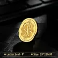 Vintage golden oval metal wax seal stamp head featuring an ornate engraved letter P design - Letter P