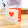 Creative white greeting card with heart cutout and red I miss you text on wooden table - Heart Card (GA146)
