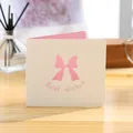 Elegant white folding greeting card featuring pink hollow bow and Best Wishes message - Bow Card (GA146)