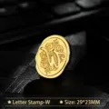Vintage gold metal wax seal stamp head featuring an ornate decorative letter W design - Letter W