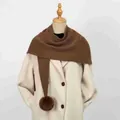 Close-up of brown knitted shawl with pom-pom decoration on mannequin - 86*36cm / Coffee