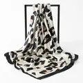 Detailed macro view of a luxury satin leopard print square scarf draped elegantly on a frame - 90*90cm / Black And White