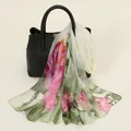 Elegant floral print chiffon scarf in pink and green, draped over a black bag as a sku image. - Floral Print Style (YSY071-3)