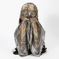 Back view detail of a satin square scarf with paisley print tied elegantly as a headscarf. - 70*70cm / FH175-02# Light Coffee