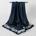 Macro view of navy blue polka dot square scarf with intricate paisley border detail - Navy Blue / 90x90cm