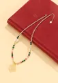 Detailed view of a New Chinese style beaded necklace with a pale yellow pendant - Citrine Style