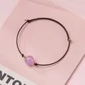 Handmade woven cord bracelet featuring a pink strawberry quartz crystal bead for women - Lavender Amethyst - Black Rope