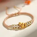 Bracelet en cordon pêche tissé à la main avec breloque serpent dorée et nœuds floraux - Noeud de Fleur de Pêcher Serpent de la Chance / Beige