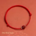 Handmade red cord bracelet with a single carved Nanhong agate bead and gold accents - Lotus Bud Cinnabar Braided Cord