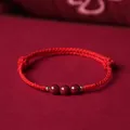 Handcrafted red rope bracelet with three natural Liangshan Nanhong agate beads. - Three Purple Gold Cinnabar Bracelet