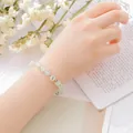 Elegant mint green beaded bracelet with gold spacers worn on a woman's wrist lifestyle - Prehnite Bracelet